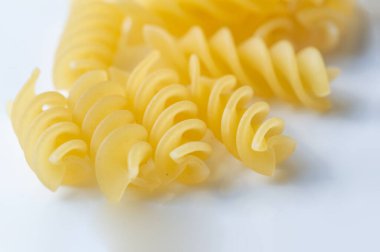 Short pasta. Fusilli, commonly known as rotini in the United States, is a variety of pasta that has a corkscrew or spiral shape. The word fusilli is believed to be derived from fuso (