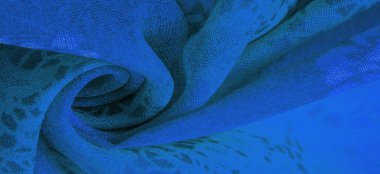 Green silk fabric with floral print. Clothing design. Modern floral background. Modern exotic jungle plants. Tinting, sunlight effect. Texture, background, design.