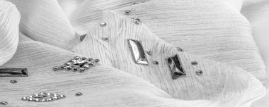 Süslü, süslemeli taşlı beyaz kumaş. parlak renkli taşlarla dokuma arkaplanı, doku arkaplan tasarımı. İpek deseni,