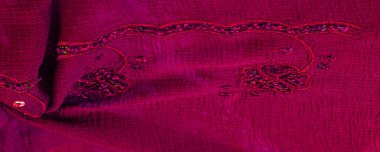 Silk red. The fabric is embellished with sequins. background, silk satin, luxurious texture, dark fabric, costume cotton material, abstract color image pattern, delicate liquid emerald velvet