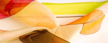 red, white and yellow geometric colors, made of fine viscose silk. organza pattern. Texture. Background fine knitted fabric - light transparent,