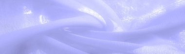 pale blue silk fabric. thin, strong, soft, shiny fiber produced by silkworms. the feel, appearance, or consistency of a surface or a substance. Texture. Background.