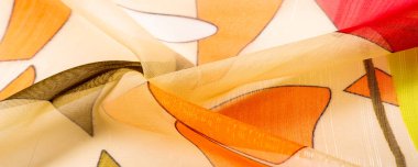 red, white and yellow geometric colors, made of fine viscose silk. organza pattern. Texture. Background fine knitted fabric - light transparent,