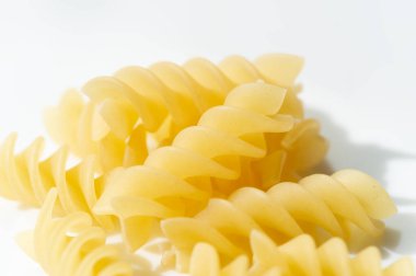 Short pasta. Fusilli, commonly known as rotini in the United States, is a variety of pasta that has a corkscrew or spiral shape. The word fusilli is believed to be derived from fuso (