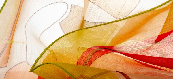red, white and yellow geometric colors, made of fine viscose silk. organza pattern. Texture. Background fine knitted fabric - light transparent,
