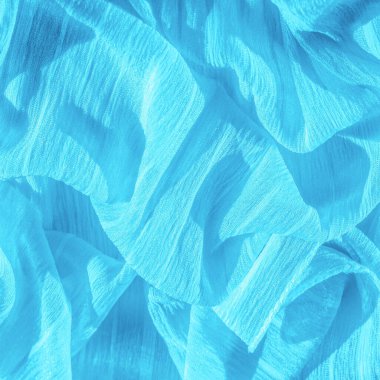 İpek kumaş. Mavi buruşuk kumaş dokusu. Mavi buruşuk, dalgalı yüzey dokusu. Yakın çekim, yumuşak odaklanma. arkaplan, kalıp