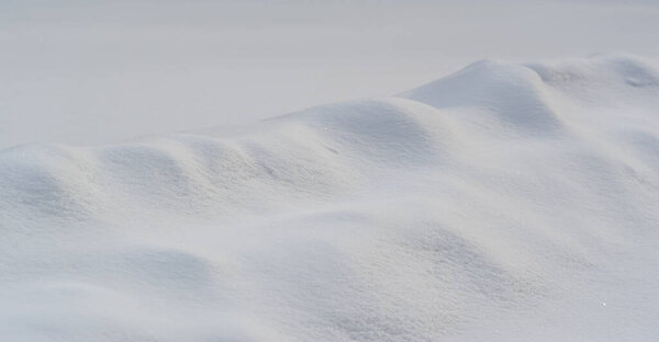 Snow texture atmospheric water vapor frozen into ice crystals and falling in light white flakes or lying on the ground as a white layer.