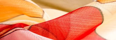 red, white and yellow geometric colors, made of fine viscose silk. organza pattern. Texture. Background fine knitted fabric - light transparent,