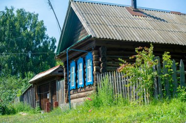 Old wooden house. Coniferous log house. Under the rising sun, wind and frost. a lot of time. the tree turned black from the weather.