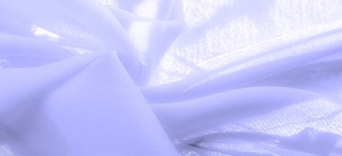 pale blue silk fabric. thin, strong, soft, shiny fiber produced by silkworms. the feel, appearance, or consistency of a surface or a substance. Texture. Background.