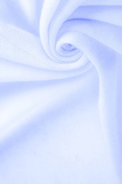 Mavi kumaş, lüks kumaşın soyut arkaplanı ya da dalgaların sıvı ipek dokusu ya da dalgalı kıvrımlar. arka plan ya da zarif duvar kağıdı tasarımı. Pamuk dokusu, doğal kumaş ve boya.