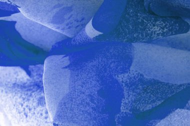Abstract blue silk chiffon fabric. Artistic layout in denim silk taffeta color. Texture. background. template.