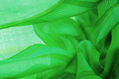 Tayftaki mavi ve sarı arasındaki rengin yeşil, çimen ya da zümrüt renginde ipek kumaş. Doku. Arkaplan.