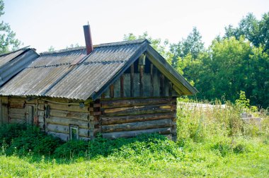Old wooden house. Coniferous log house. Under the rising sun, wind and frost. a lot of time. the tree turned black from the weather.