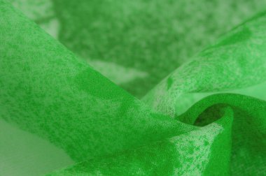 Abstract green silk chiffon fabric. Art mockup of spring green color taffeta silk fabric. Texture. background. template.