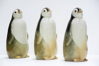 three figures with the image of penguins. painted with porcelain paints. collectibles. Swap meet. Antiques, art.