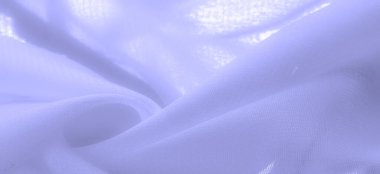 pale blue silk fabric. thin, strong, soft, shiny fiber produced by silkworms. the feel, appearance, or consistency of a surface or a substance. Texture. Background.