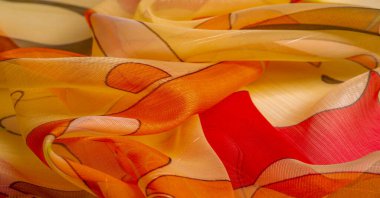 red, white and yellow geometric colors, made of fine viscose silk. organza pattern. Texture. Background fine knitted fabric - light transparent,