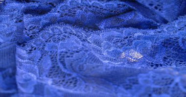 Mavi dantel. Elastik moda tekstil jakuzi danteli. Seksi iç çamaşırları için dekoratif bir şey. Lastik bantlar. Ev dekoru. Tasarımın için doku. Geçmişi. şablon.