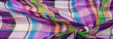 İskoç dokusunun arka plan dokusu, ki bu dokunun adı doğrudan ülkenin kökenini gösterir. Bu materyalin ikinci ve daha doğru adı tartan..