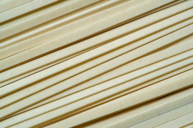 Linguine pasta. Linguini is usually made from both white flour and whole grains, but it was originally made from durum wheat. originated in Italy and is based on more traditional pastas.