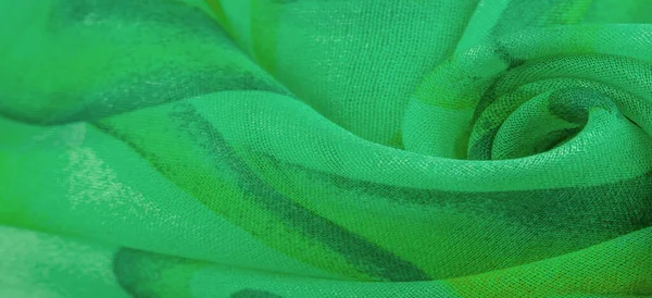 green fabric texture with abstract green print. luxury as abstract background. Luxury Christmas background. Fabric, delicate.