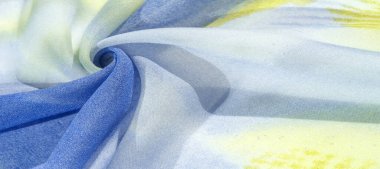 Yumuşak mavi, soyut desenleri ve yatak tonları olan ipek kumaş, sarı ve beyaz tonlarda. Doku, desen, koleksiyon