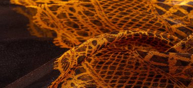 Tekstil malzemesinden kahverengi arka plan. dantel kumaş. Doğal kehribar dokusu. Doku, arkaplan, desen.