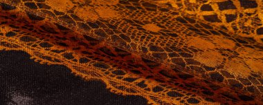 Tekstil malzemesinden kahverengi arka plan. dantel kumaş. Doğal kehribar dokusu. Doku, arkaplan, desen.
