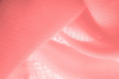 red pink silk fabric. a fine, strong, soft, lustrous fiber produced by silkworms in making cocoons and collected to make thread and fabric. Texture. Background.