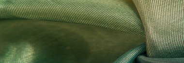 Arkaplan dokusu, ipek kumaş, parlak yeşil yeşil renk, küçük soyut kaya resimleri..