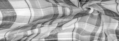 İskoç dokusunun arka plan dokusu, ki bu dokunun adı doğrudan ülkenin kökenini gösterir. Bu materyalin ikinci ve daha doğru adı tartan..