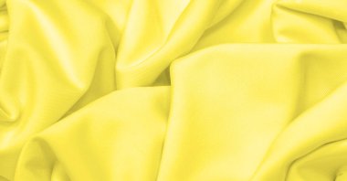 Kumaş sarı ipek. Doku. Geçmişi. Şablon. İpek kumaşın parlak bir parıltısı ve yatay olarak çalışan karakteristik küçük kıvrımları vardır. Yumuşak kıvrımlar içinde uzanır