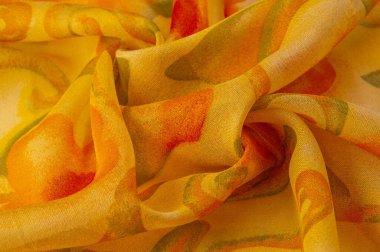 yellow fabric texture with abstract red print. luxury as abstract background. Luxury Christmas background. Fabric, delicate. Smooth elegant