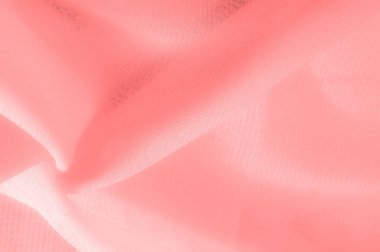 red pink silk fabric. a fine, strong, soft, lustrous fiber produced by silkworms in making cocoons and collected to make thread and fabric. Texture. Background.