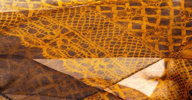 Tekstil malzemesinden kahverengi arka plan. dantel kumaş. Doğal kehribar dokusu. Doku, arkaplan, desen.