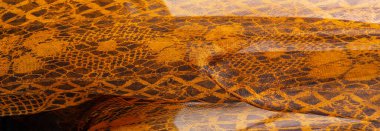 Tekstil malzemesinden kahverengi arka plan. dantel kumaş. Doğal kehribar dokusu. Doku, arkaplan, desen.