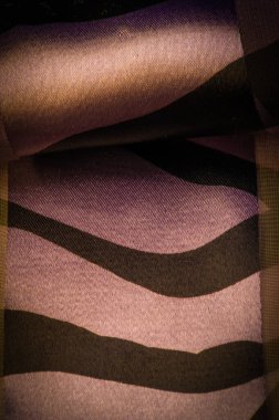 silk fabric in abstract brown and blue-yellow tones. Abstract watercolor paint, painted textured vertical silk fabric, canvas, macro, close-up, pastel. Texture. Background. Pattern.