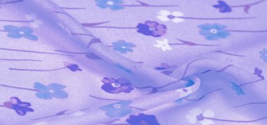 İpek kumaş, eflatun arkaplanda küçük çiçekler, ince bir desenli gök mavisi. Çiçek tasarımı. Arkaplan dokusu