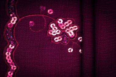 Silk red. The fabric is embellished with sequins. background, silk satin, luxurious texture, dark fabric, costume cotton material, abstract color image pattern, delicate liquid emerald velvet