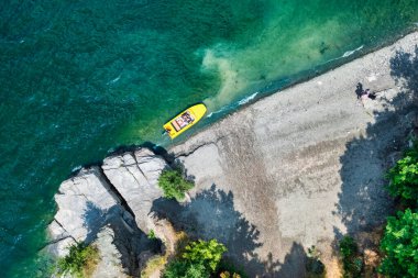 Aerial view from a drone on a beach and a boat, on the coast of the Dniester river, in Ukraine, Bakota