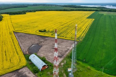 Aerial view video of telecommunication tower, in the countryside farming fields with 4G, 5G cellular network antennas.