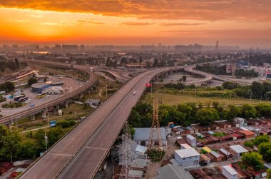 Aerial view over evening traffic in Kiev, Ukraine. Highway and overpass with cars and trucks, interchange, two-level transport interchange, in a big city.