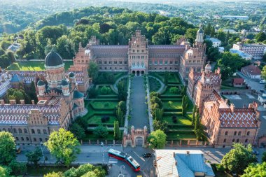 Aerial view of Yuriy Fedkovych National University, Seminar Residence and Church of the Three Hierarchs. Old historical university building with towers, domes, and green garden Chernivtsi, Ukraine