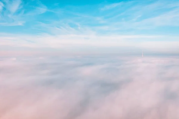 Sky above the clouds, aerial view of thick fog and clouds lying above the ground, beautiful landscape, and background