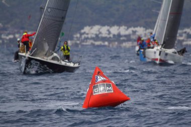Bodrum, Hindi. 25 Mart 2018: Yelkenliler Ege Denizi 'nin mavi sularında, ünlü tatil beldesi Bodrum' un kıyılarında rüzgarlı havada yelken açıyor..