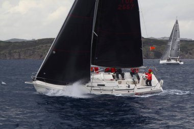 Bodrum, Hindi. 02 Mart 2019: Yelkenliler Ege Denizi 'nin mavi sularında, ünlü tatil beldesi Bodrum' un kıyılarında rüzgarlı havada yelken açıyor.
