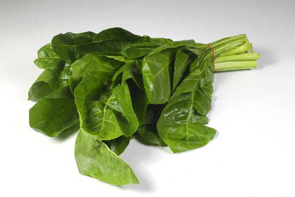 Bunch of fresh chard leaves on white background. Top view.