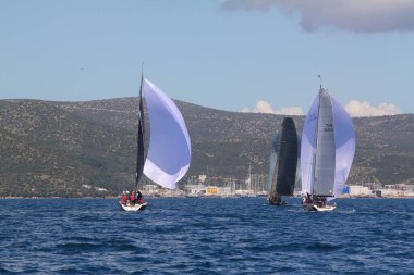 Bodrum, Hindi. 14 Nisan 2019: Yelkenliler Ege Denizi 'nin mavi sularında, ünlü tatil beldesi Bodrum' un kıyılarında rüzgarlı havada yelken açıyor..