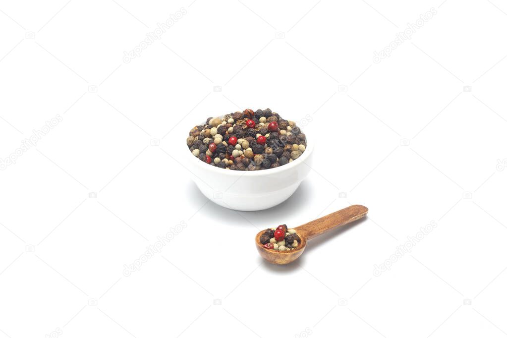Pepper mix in bowl isolated on white background, top view.
